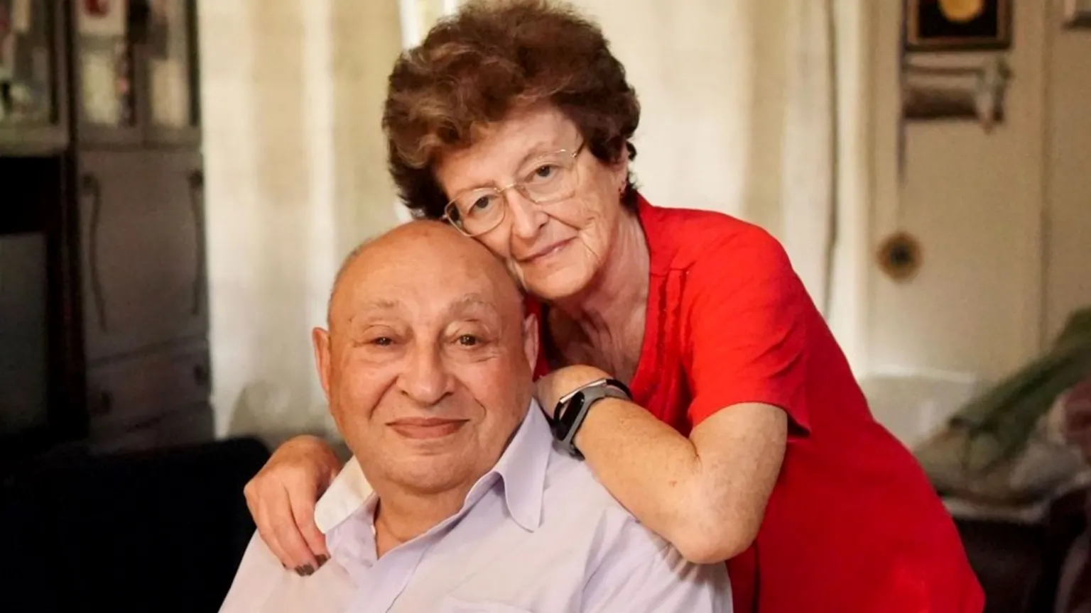 Police/Family handout A woman leans on the shoulders of a man who is smiling, both look towards the camera.
