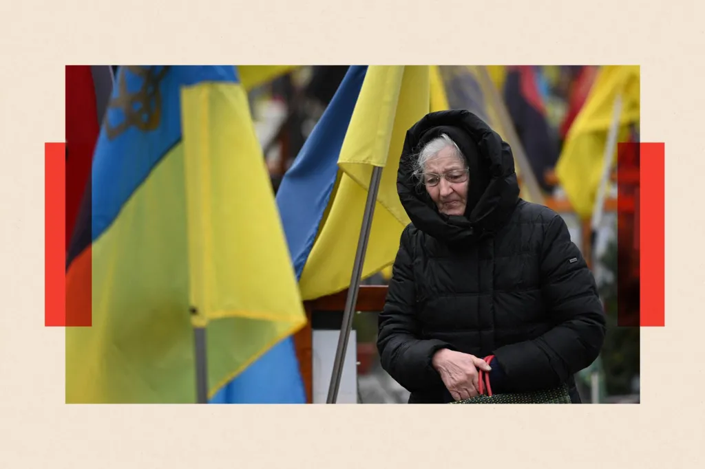 AFP via Getty Images A woman mourns among graves of Ukrainian servicemen at the Lychakiv cemetery